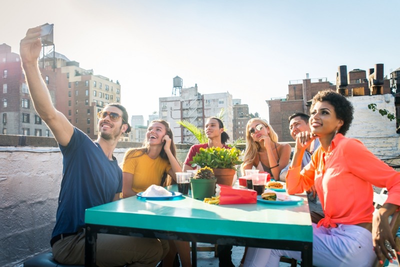 Best Rooftop Bars Charleston: A group of young adults pose for a selfie atop one of the best rooftop bars in Charleston, SC.