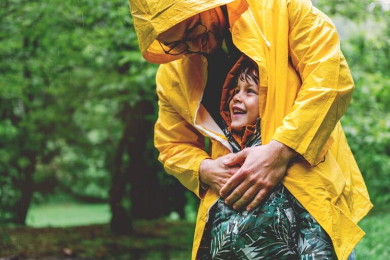 Things to Do in Charleston: A father and son smile during a rainy day in Charleston.